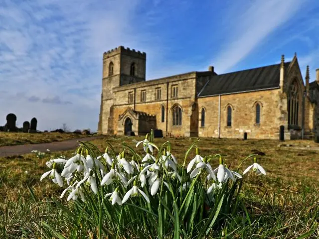 Snowdrops in front of a church