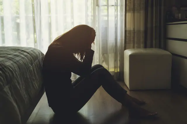 Young woman holding her head in her hands