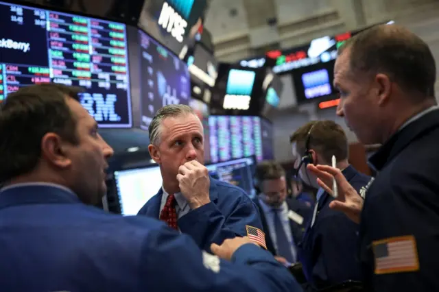 market traders watch tech stocks