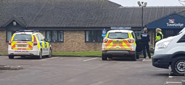 Police vehicles at Travelodge in Ely