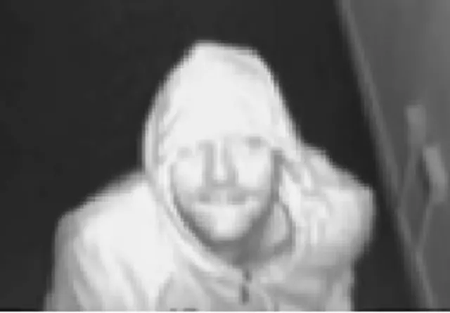 CCTV image of man with hood up