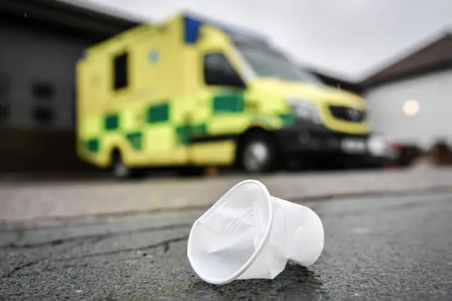 Plastic cup by an ambulance