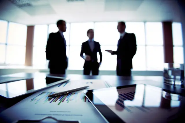 Three men in an office