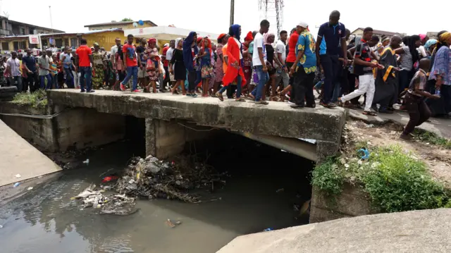 People walking over a bridge in Lagos