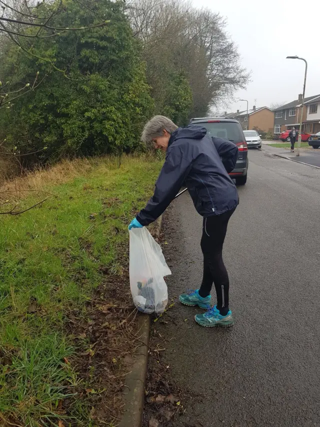 Plogger picking up litter