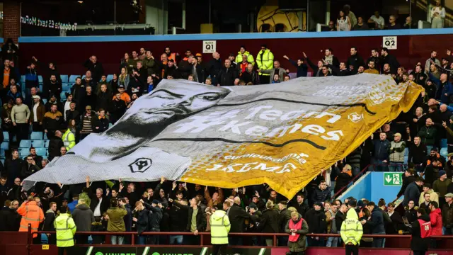 Wolves fans hold a Carl Ikeme flag