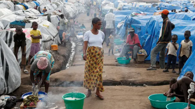 A woman walks at an internally displaced persons (IDP) camp in Bunia