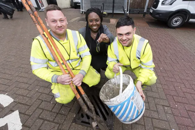 Construction workers and one council officer by the drain