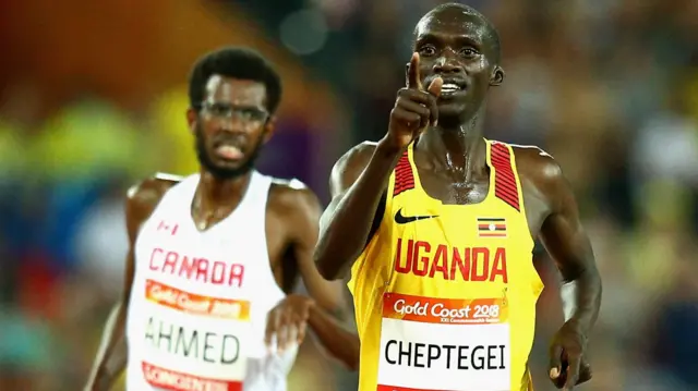 Uganda’s Joshua Cheptegei with Canada's Mohammed Ahmed behind him