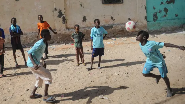 Boys playing football in Mogadishu, Somalia