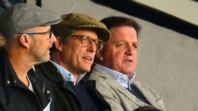 Hugh Grant watches on