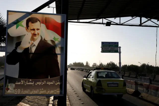 A large poster of Syrian President Bashar al-Assad on the road to the airport in Damascus