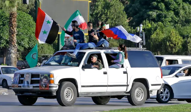 Syrians waving the national flag in Damascus