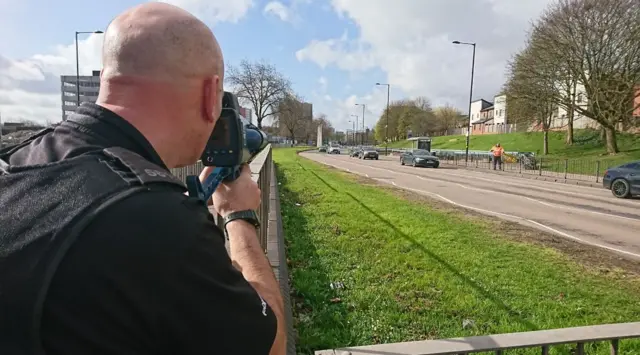 Police officer with speed camera