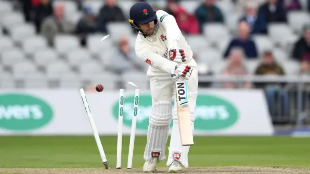 Steven Croft's off stump flies out of the ground as he is bowled by Jake Ball