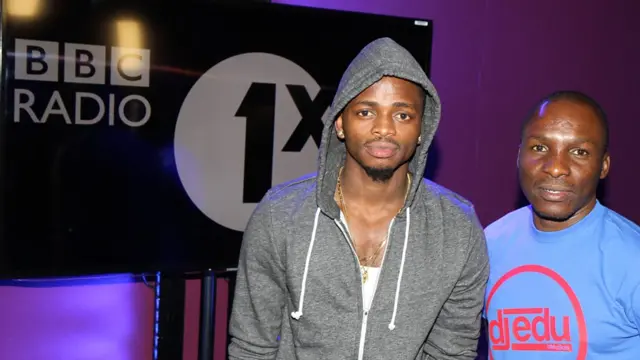 Diamond Platinumz stands next to  DJ Edu in the studios of BBC radio station 1xtra