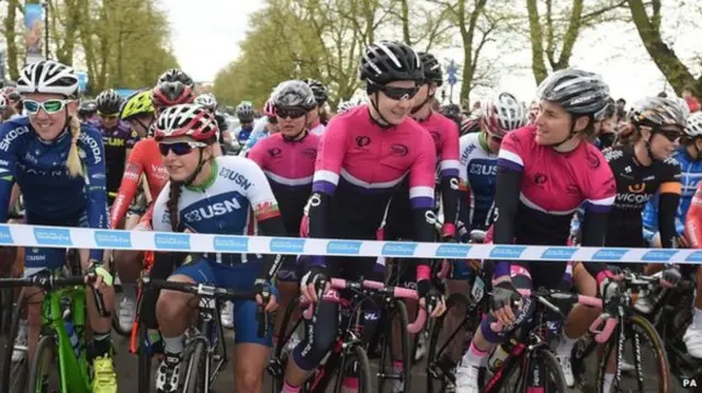 Cyclists line up at the start of a race