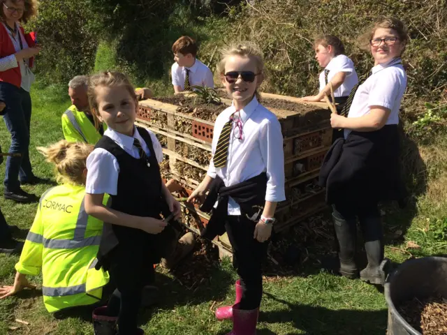 children building a bug hotel out of pallets