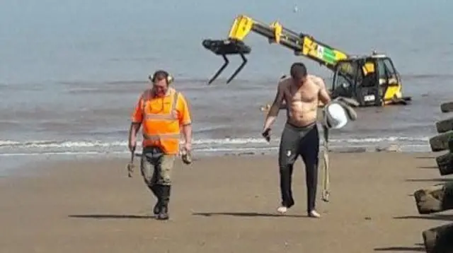 Digger stranded on beach