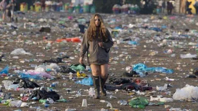 Reveller walks through festival waste