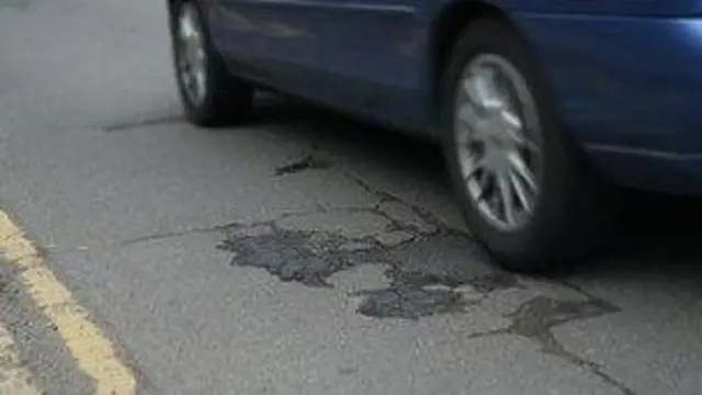 A car driving over a pothole