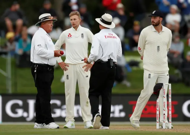 Joe Root consults with the umpires