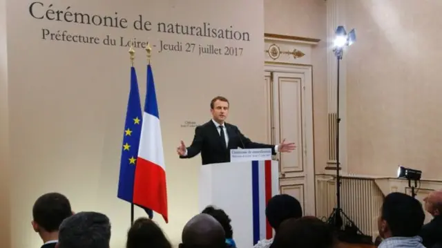 President Emmanuel Macron stands a lectern as he delivers a speeh at a citizenship ceremony in Orleans in 2017