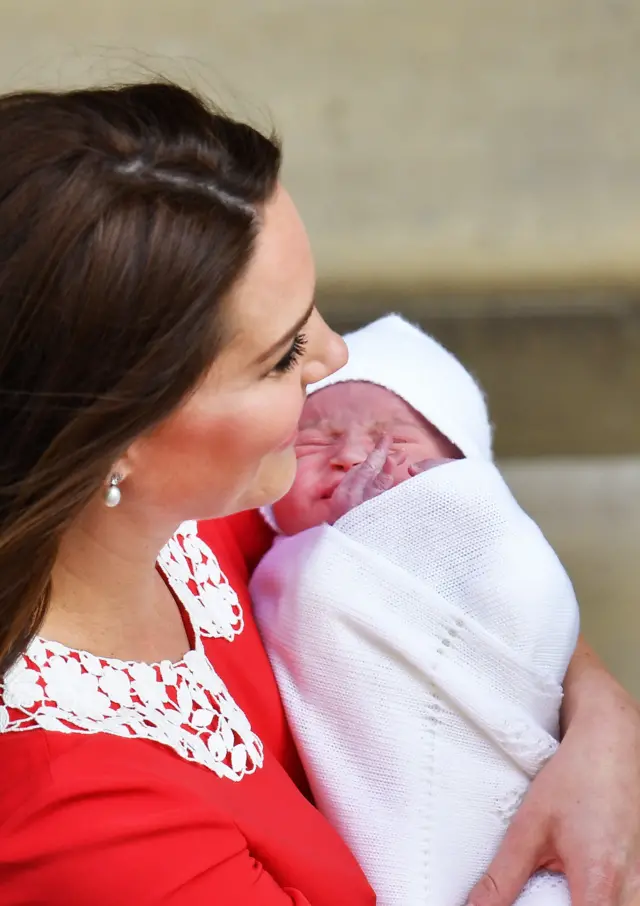 The new prince cradled by a beaming Catherine