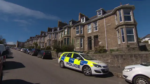 Police car in terraced street