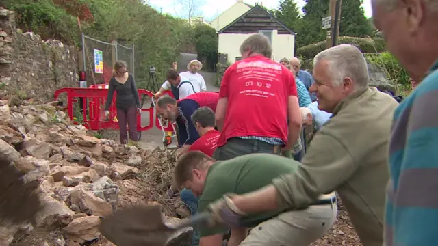 Locals clearing a landslide in Totnes