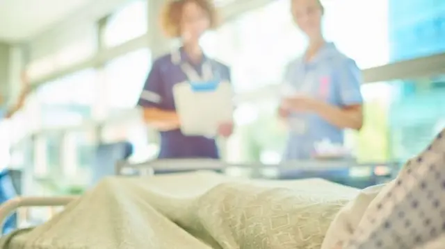 Health staff looking over patient