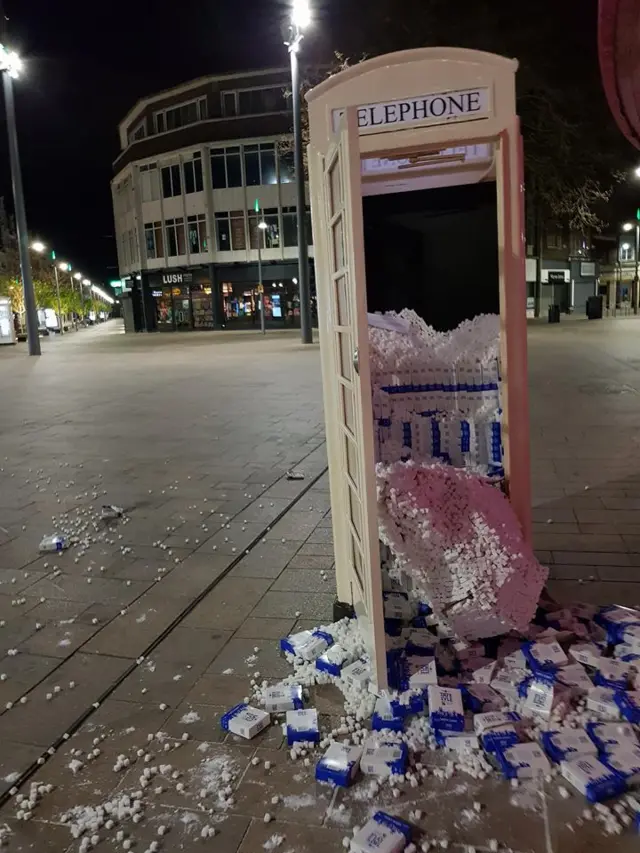 Smashed up phone box