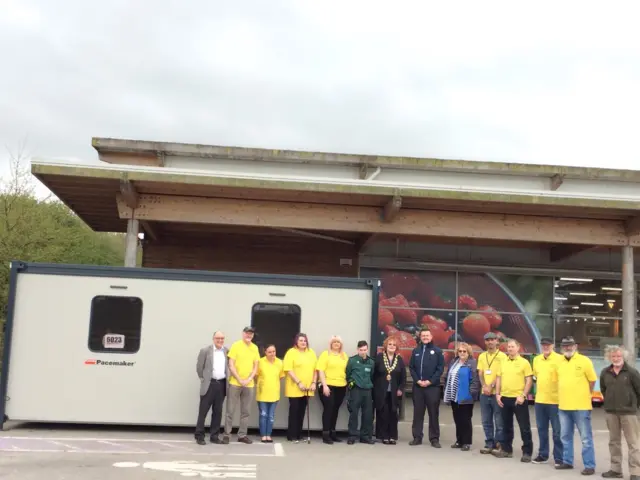 Campaigners pose with new cabin