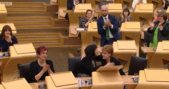 Social Security Minister Jeane Freeman gets a well earned hug from the first minister