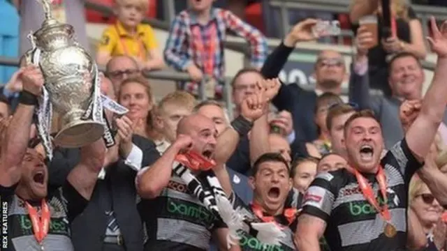 Hull FC players hold up the Challenge Cup in 2017