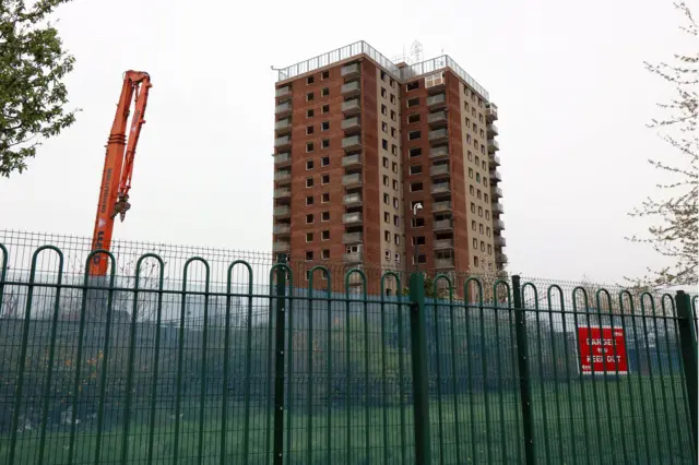 Crane next to tower block