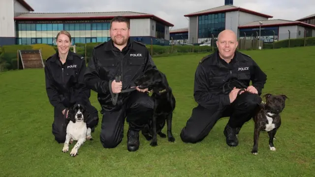 The three qualified police dogs with their handlers