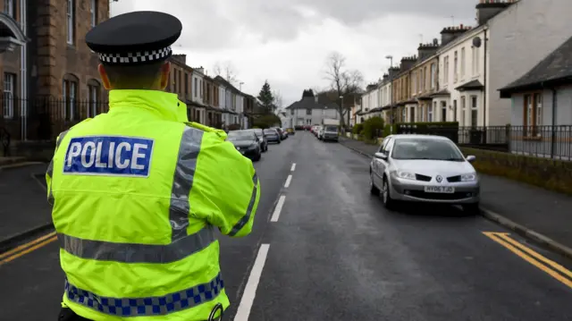 Police officer by a cordon