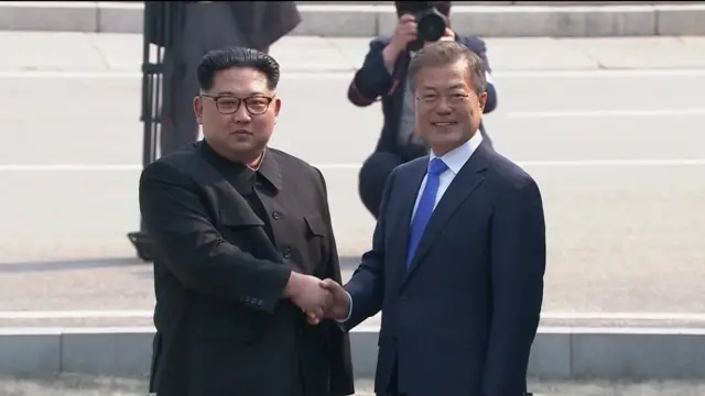 Kim and Moon shake hands