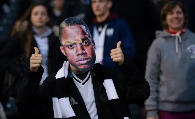 A fan in a Ryan Sessegnon mask