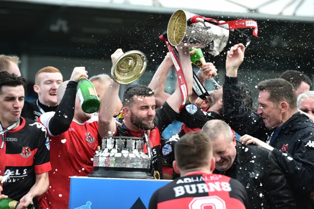 Crusaders manager Stephen Baxter joins the celebrations at Ballymena Showgrounds