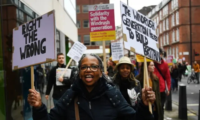 Protesters carry slogans that read "Right the wrong"