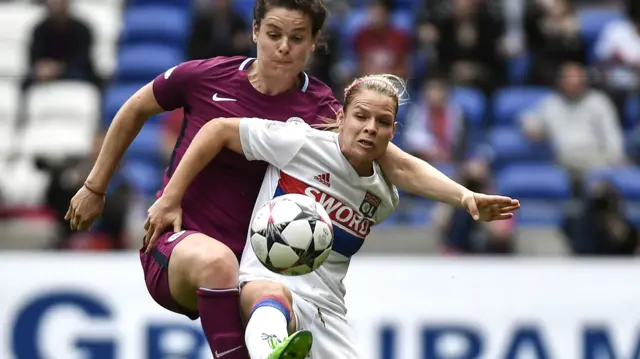 Eugenie Le Sommer challenges for the ball with Jen Beattie