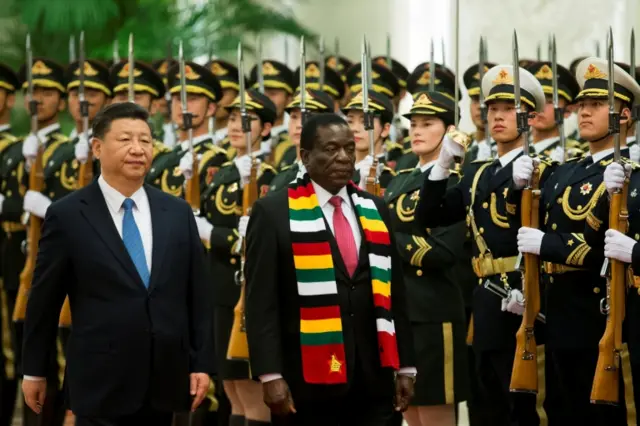 President Xi Jinping of China and President Emmerson Mnangagwa of Zimbabwe walk in front of Chinese soldiers