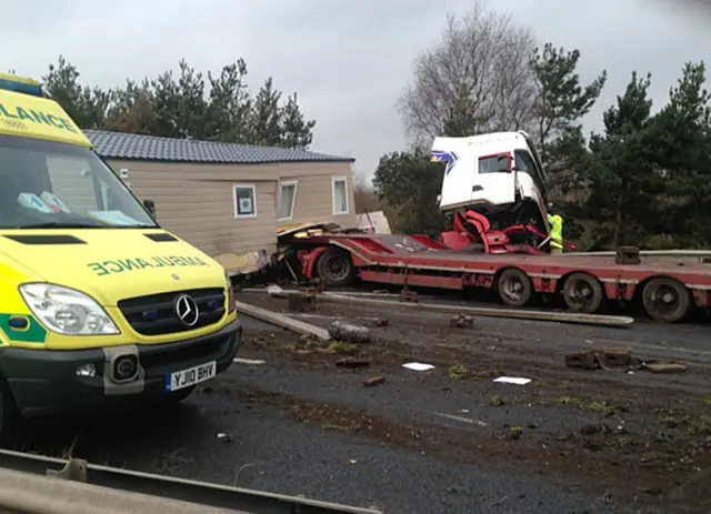 Smashed up lorry and ambulance