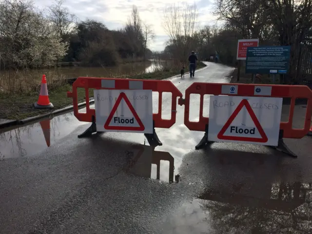 Road closed signs next to river in Beverley