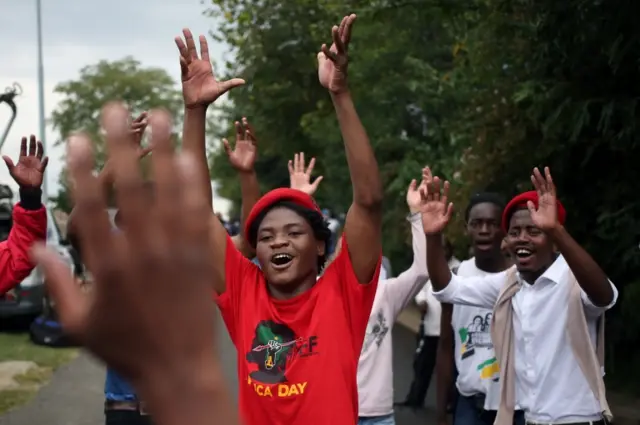 Mourners chant slogans outside the home of the late Winnie Mandela in Soweto, South Africa