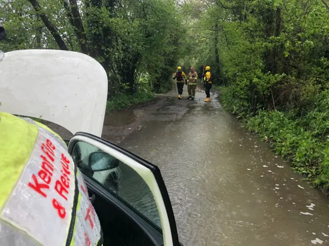 Firefighters rescuing people from a car