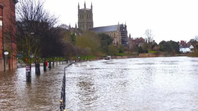 The riverside road flooded by the River Severn in Worcester.