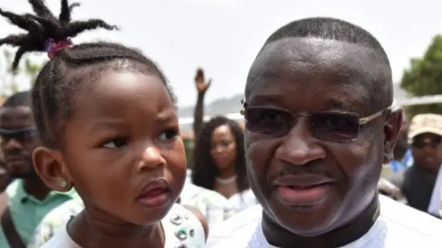 Julius Maada Bio holding a child - March 2018